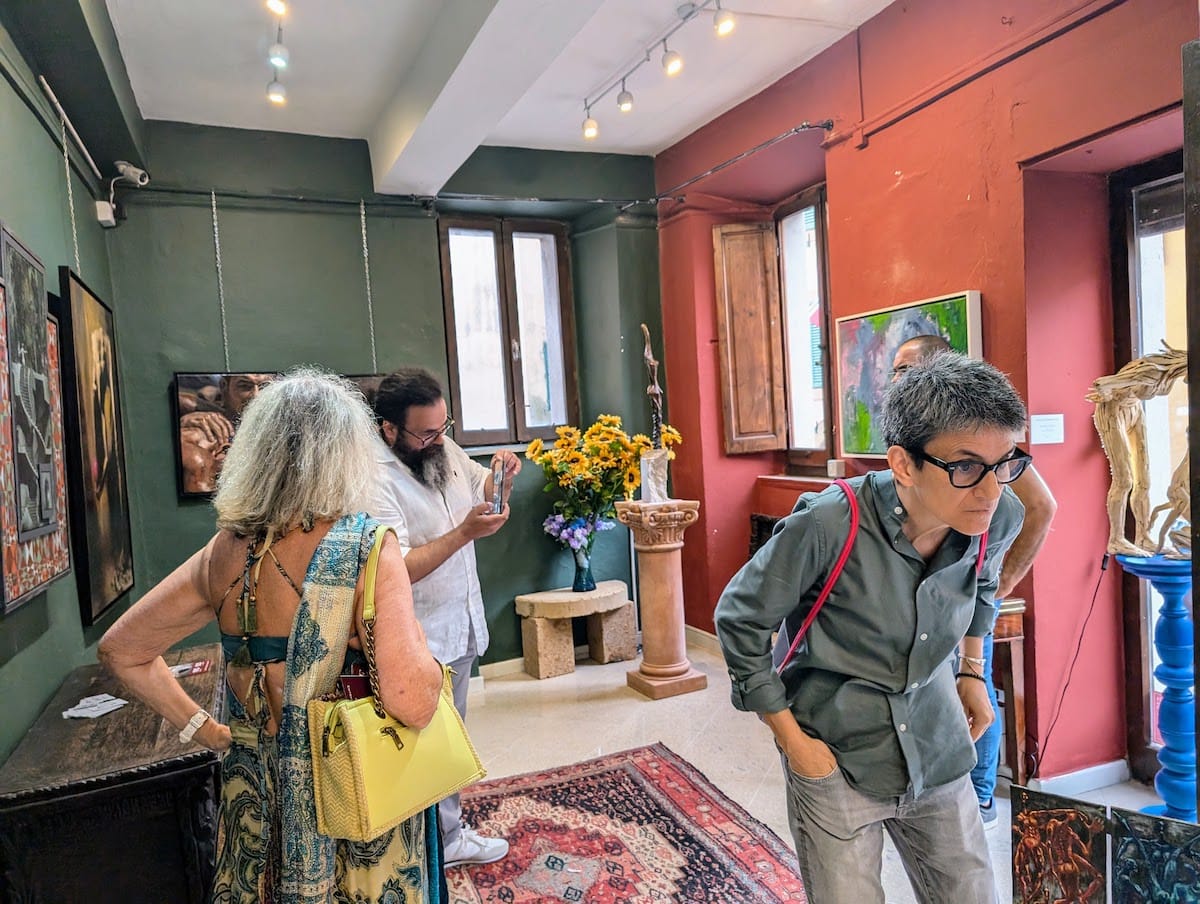 Visitors among the works in the salon.