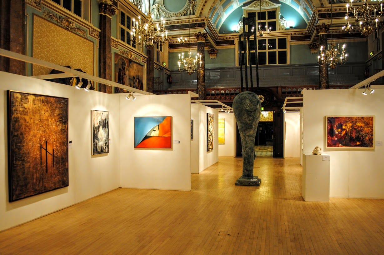 The main hall hung for the Biennale, seen across the parquet in the evening light.