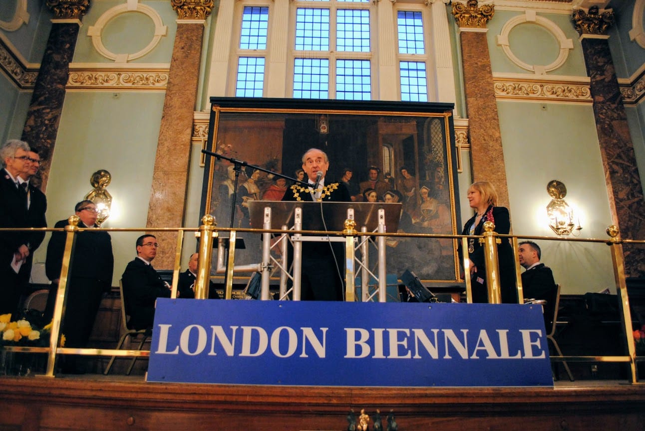 The opening address from the balcony of the main hall, beneath the London Biennale banner.