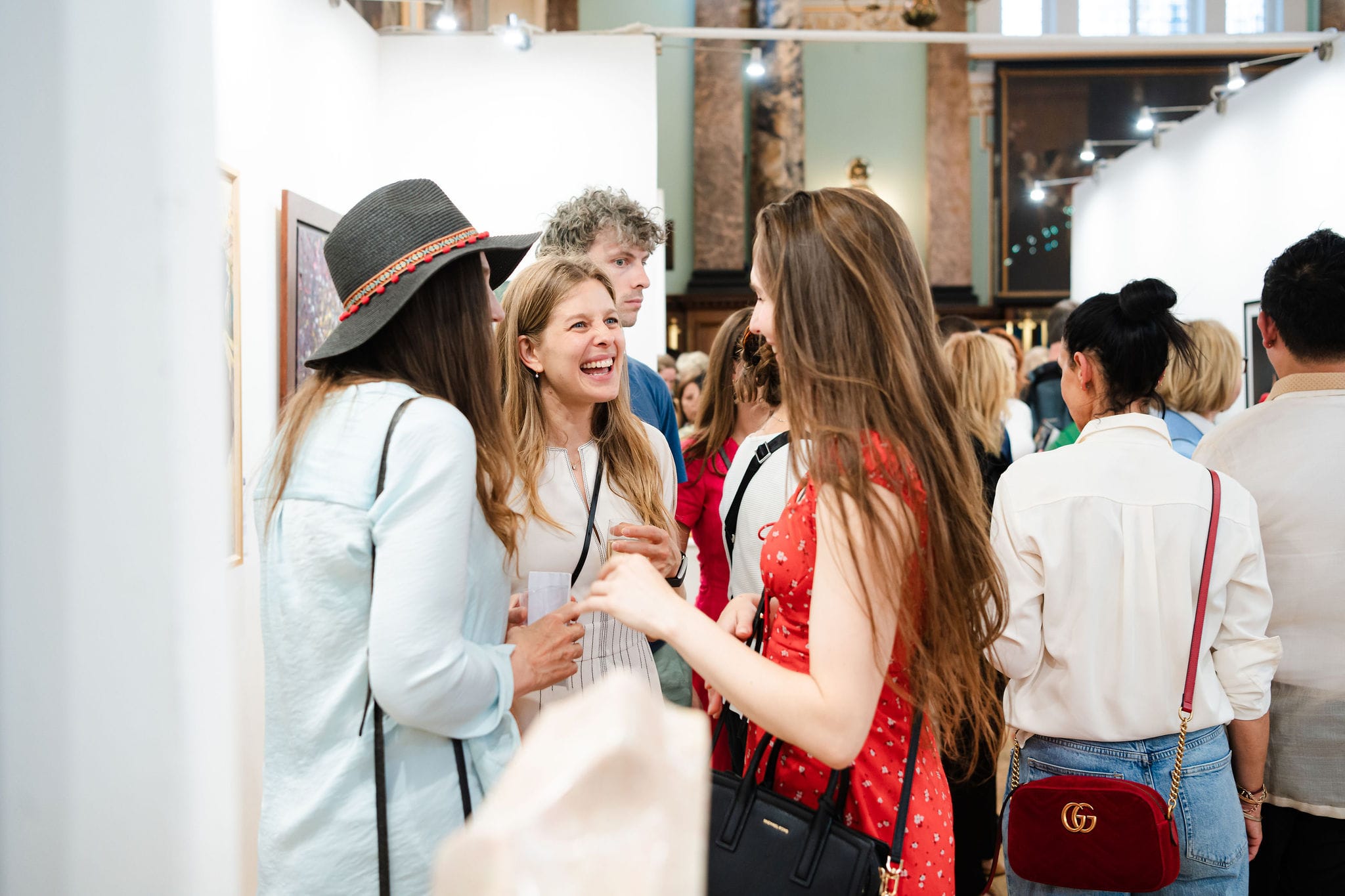 Laughter in the crowd at the private view.
